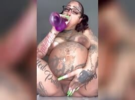 Squirting on her purple dildo 